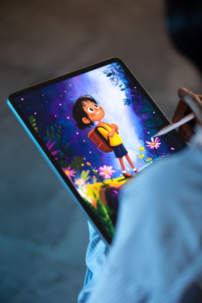 Artist creating colorful digital illustration on a tablet using a stylus, showcasing a child character.